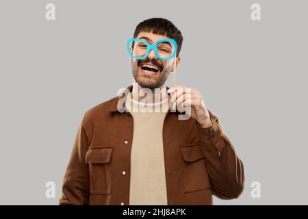 happy smiling man with glasses party accessory Stock Photo