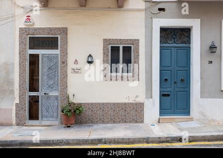 Marsaxlokk, Malta - 01 07 2022: Blue wooden doors of a residential street Stock Photo