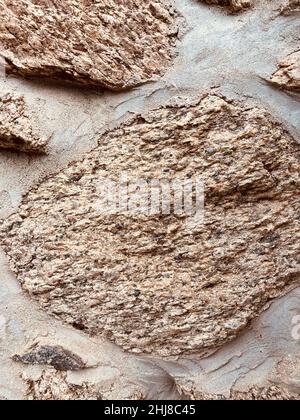 close up of wall made of gray irregular granite stones Stock Photo