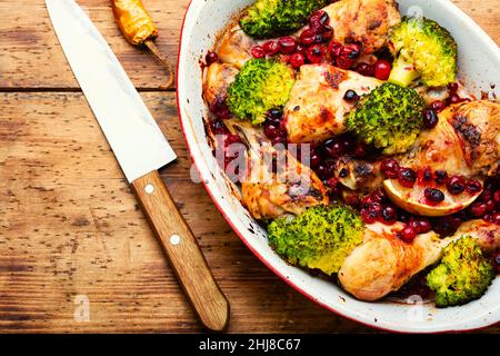 Fried chicken legs, chicken drumsticks with broccoli and cranberries Stock Photo