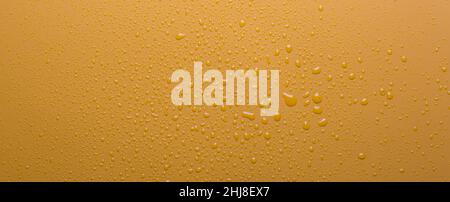 Water drops on orange color  surface Stock Photo