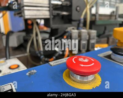 The Emergency stop button on control cabinet of   press machine. Stock Photo