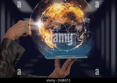 Hand holding the lablet and pointing the particle of earth over the Background blurred of server room, business innovation and technology concept Stock Photo