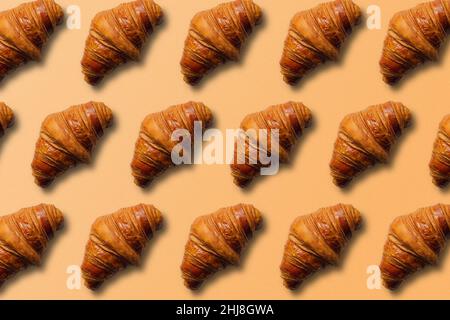 Horizontal croissant pattern with orange background and copy space. Stock Photo