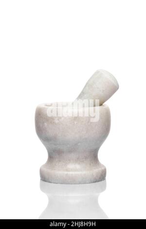 A simple kitchen mortar and pestle for grind ingredients. Set of tools for preparing substances by crushing and grinding them into a fine paste or pow Stock Photo