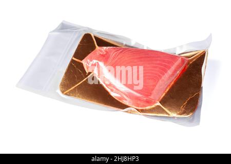 Fresh tuna fillet vacuum packed. Fish steak on a white background. Red fish textured steak isolated. Stock Photo