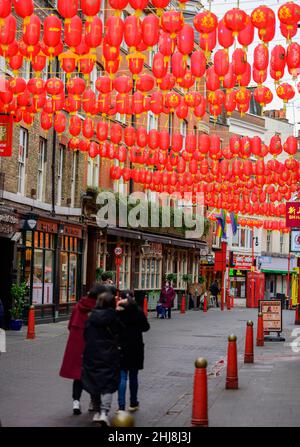 London, UK. 27 January 2022. A grey morning in the capital with few shoppers and visitors is brightened up with lanterns strung across Chinatown. Stock Photo