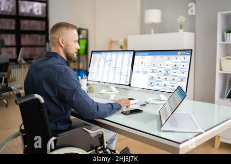 Employee Working On Calendar Schedule And Staff Time Sheet Stock Photo