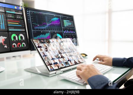 Watching Online Video Conference Meeting In Office Stock Photo