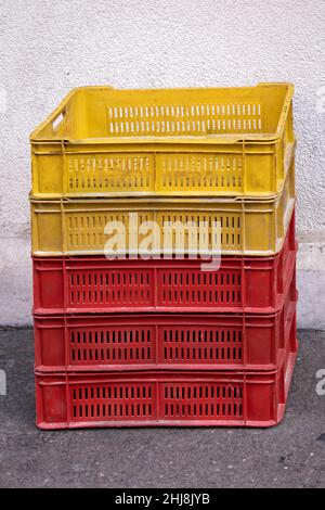 Stack of empty plastic crates on the ground pavement Stock Photo