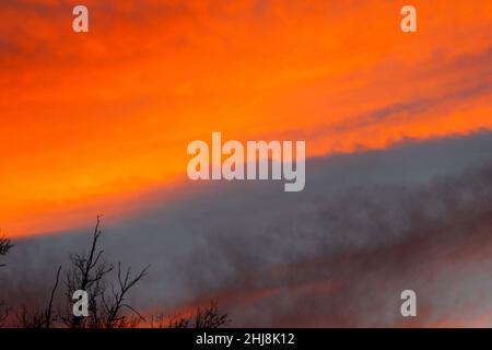 Fiery Looking Clouds at Sunset in Winter Stock Photo