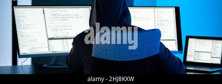 Hacker Using Computer To Write Cyber Security Exploit Software Program Stock Photo