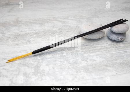 Aromatic incense sticks and stones. Stock Photo