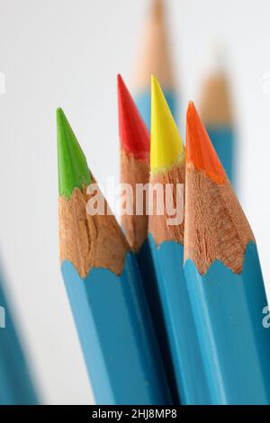 Bright coloured pencils sharpened to fine points on light background with shallow depth of field selective focus Stock Photo