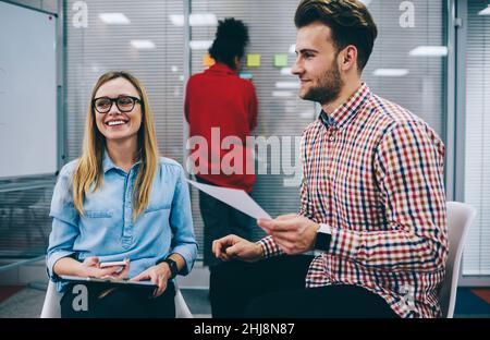 Group of coworkers talking to each other in office Stock Photo