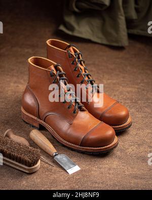 Handcrafted brown leather shoes with cobbler tools Stock Photo