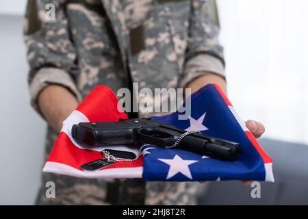 American soldier stands against white background with a flag. Concept ...
