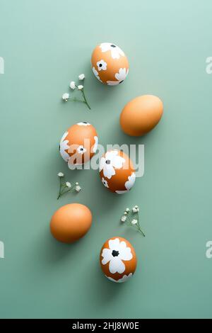 Composition with painted Easter eggs and gypsophila flowers on light ...