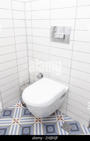 Floating toilet. Mounted toilet bowl in clean modern bathroom Stock Photo