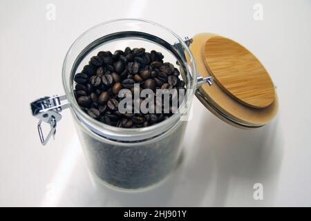 Close up of a isolated glass and wood coffee jar with its lock Stock Photo