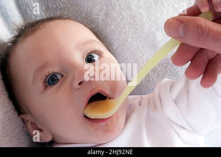 young baby being spoonfed Stock Photo