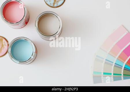 Top view of cans with paint and color palette on white background. Stock Photo