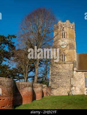 Octagonal tower and clock face and section of crinkle crankle wall, All Saints Church Easton, Suffolk, UK Stock Photo