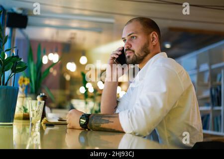 Focused man having conversation on smartphone Stock Photo