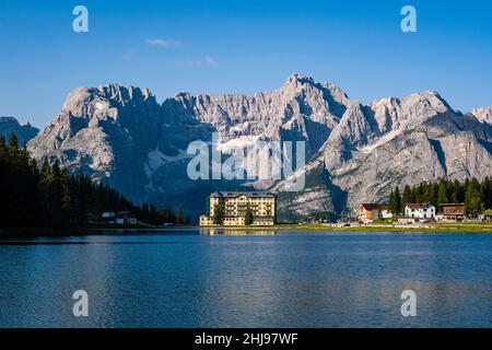 Lake and town Misurina, Lago di Misurina, with the mountain Punta Sorapiss reflecting in the water, L’istituto Pio XII at the end of the lake.