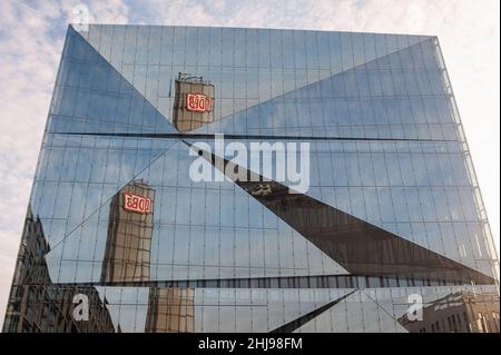 22.01.2022, Berlin, Germany, Europe - Tower of Berlin Central railway station with DB logo is reflected in the futuristic glass facade of 3XN Cube. Stock Photo