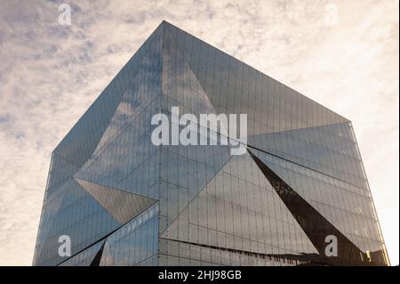 22.01.2022, Berlin, Germany, Europe - The sky is reflected in the futuristic glass facade of the new 3XN Cube building at Washingtonplatz square. Stock Photo