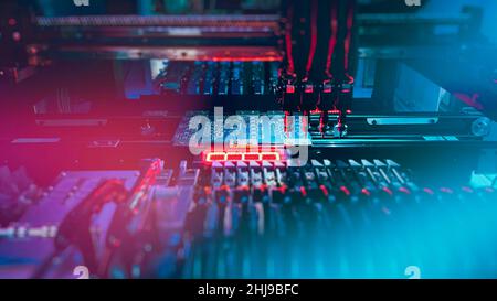 Chip Production: Machine Vision System inspect PCB for the number, size, and placement of components while and SMT manufacturing. Automatic production of computer chips by SMT Pick and Place machine.  Stock Photo