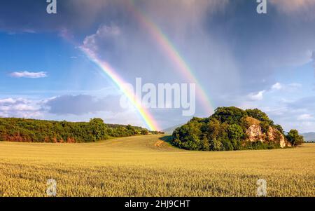 Landscape after a storm with dramatic sky and rainbow. Stock Photo