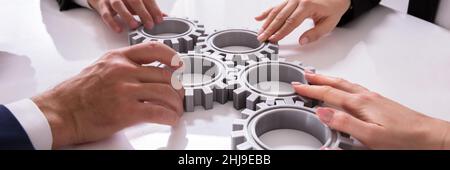 Hand Interlocking Gears. Business Partnership. Joining And Collaborating Stock Photo