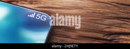 Mobile Phone Connected To 5G Network On Wireless Charger Stock Photo