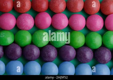 Countless candies, round, different colors. Wallpaper for gourmets, sweets lovers, fans of unhealthy lifestyle. Sugar, joy of life, fun. Like beads. Stock Photo