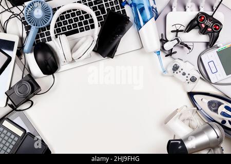 Old computers, digital tablets, mobile phones, many used electronic gadgets devices, broken household and appliances on white background. Planned Stock Photo