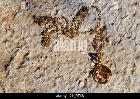 Gold necklace in the shape of earth. Stock Photo