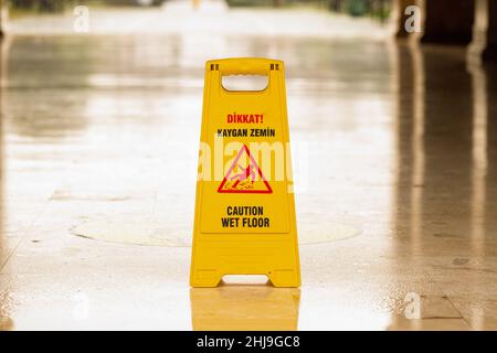 Yellow caution slippery floor sign Stock Photo