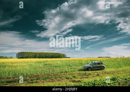 Renault Duster Suv In Spring Rapeseed Field Countryside Landscape. Duster Produced Jointly By French Manufacturer Renault And Its Romanian Subsidiary Stock Photo