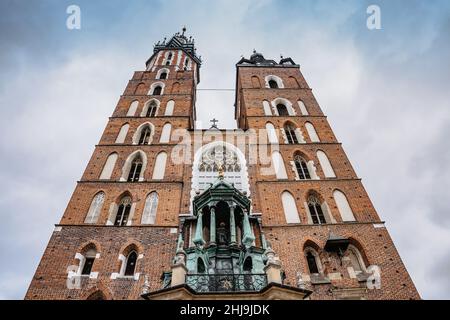 Krakow,Poland-December 17,2021.St. Mary's Basilica on Krakow Main Square,Rynek Glowny.Brick Gothic church with two towers,medieval bells,stained glass Stock Photo