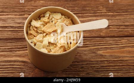Close up brown paper cup of mille-feuille custard slice cake also known as Napoleon or vanilla slice, on wooden table, high angle view Stock Photo