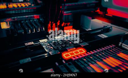 Automated manufacture of electronic railway equipment. Robot Manipulators for assembling computer chips and system computer boards place electronic components on board for fixing. Stock Photo