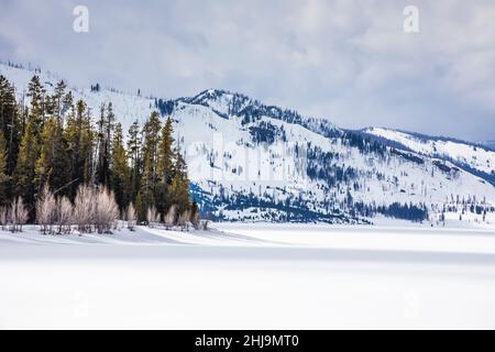 April view across still frozen Jackson Lake in Grand Teton National Park, Wyoming, USA Stock Photo