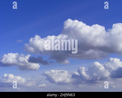 Blue sky with clouds on a sunny day in aerial view. Soft focus image of the scene with abstract heaven nature landscape. Stock Photo
