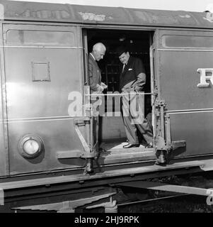 1963 Great Train Robbery was the robbery of £2.6 million from a Royal Mail train heading from Glasgow to London on the West Coast Main Line in the early hours of 8th August 1963, at Bridego Railway Bridge, Ledburn, near Mentmore in Buckinghamshire, England. Our Picture Shows ... Detective Superintendent Malcolm Fewtrell, Head of Buckinghamshire CID and Det. Supt. Gerald McArthur of Scotland Yard (wearing hat) examine  the mail carriage in the sidings at Cheddington Train Station, Friday 9th August 1963. Stock Photo