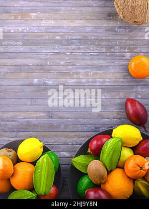 Citrus fruits on wooden background. Assorted citrus fruits and tamarillo. Coco on vintage table and another fruits. Copy space for your text. Stock Photo