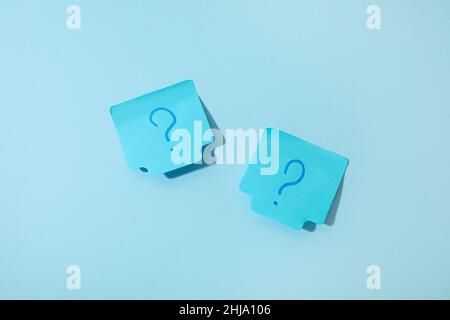 Sticky notes with question marks on blue background Stock Photo