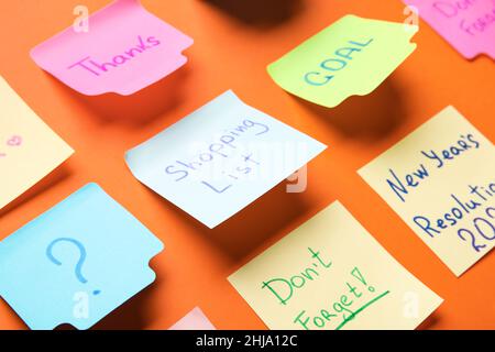 Different sticky notes on red background, closeup Stock Photo
