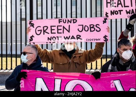 A protester holding a placard saying U.S. war machine: real threat to  peace at a rally against war with Russia sponsored by multiple groups  including CODEPINK: Women for Peace, Black Alliance for